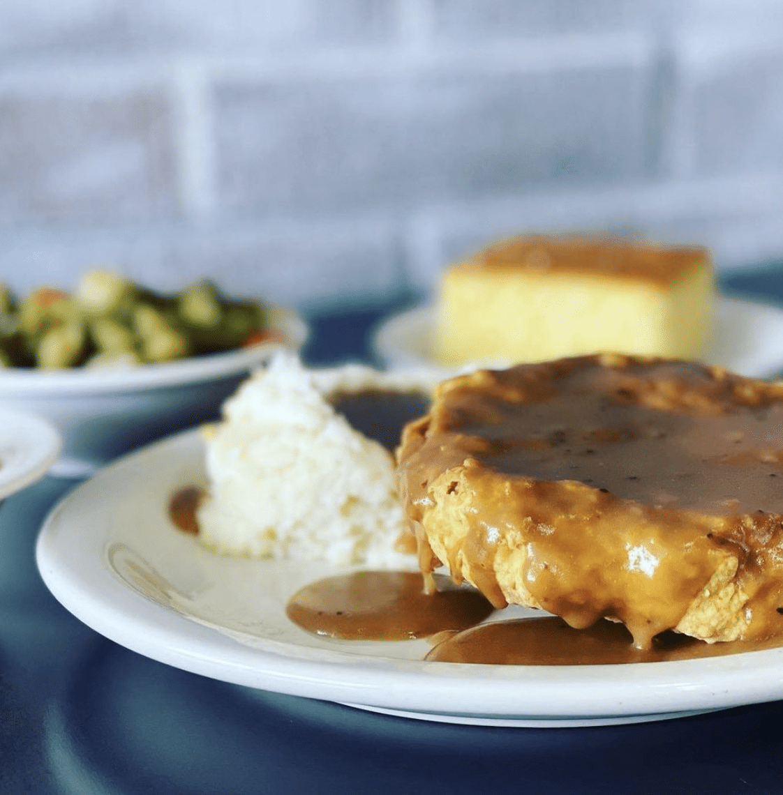 Food dripping with gravy from Cassandra's kitchen, a black owned restaurant in Houston