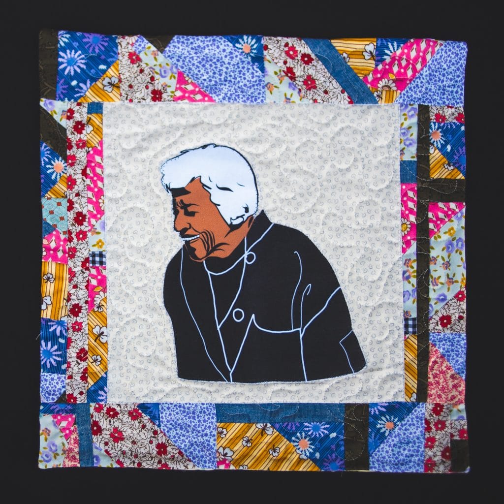 A quilted block illustrating a smiling Chef Leah Chase of Dooky Chase Restaurant in New Orleans, LA.